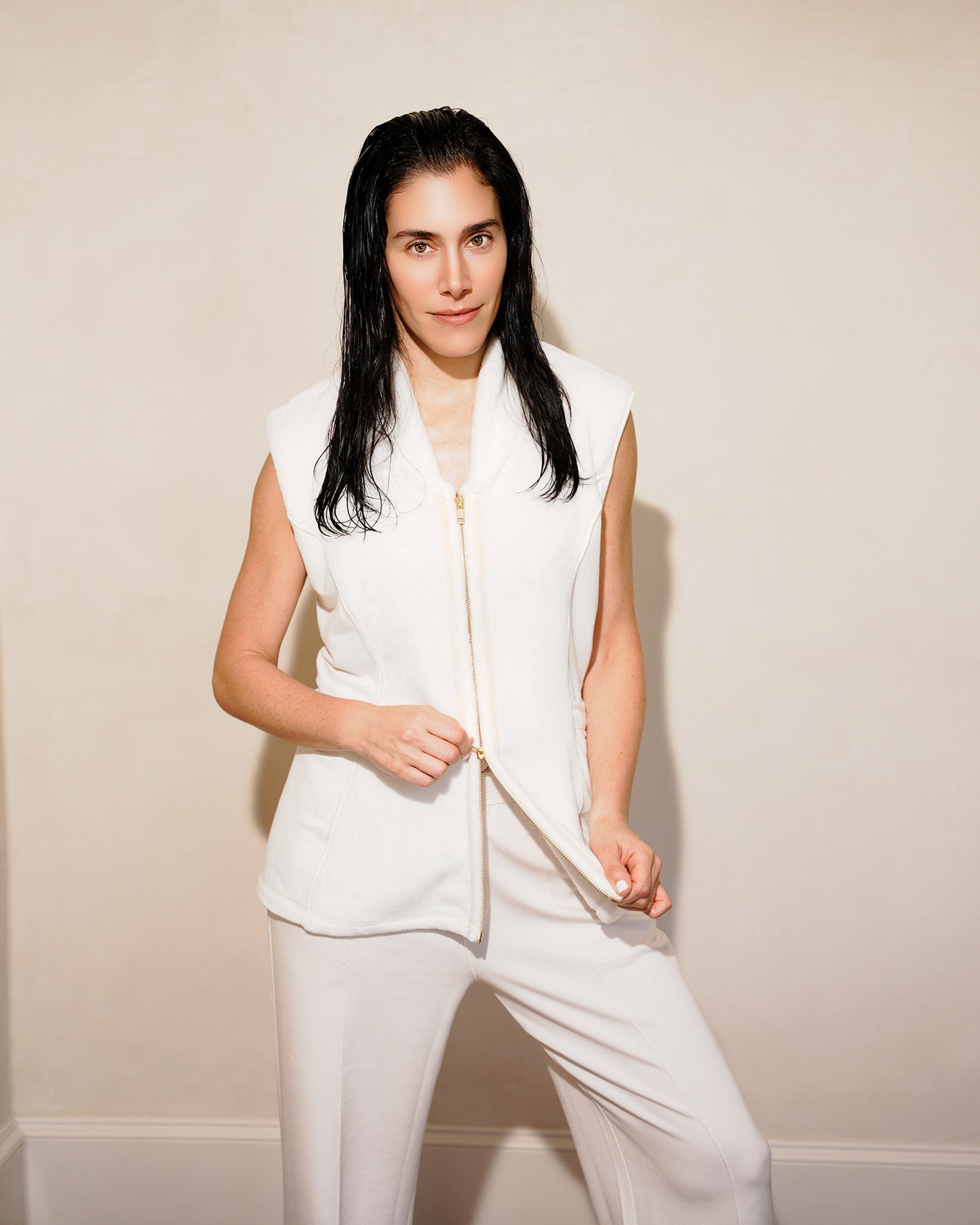 Woman wearing a post shower vest PSV against a plain background