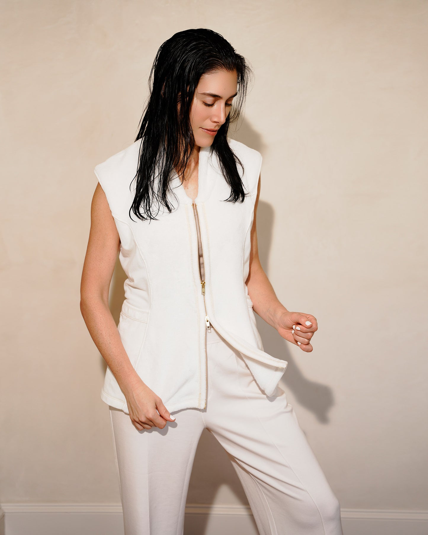 Woman wearing a post shower vest PSV against a plain background