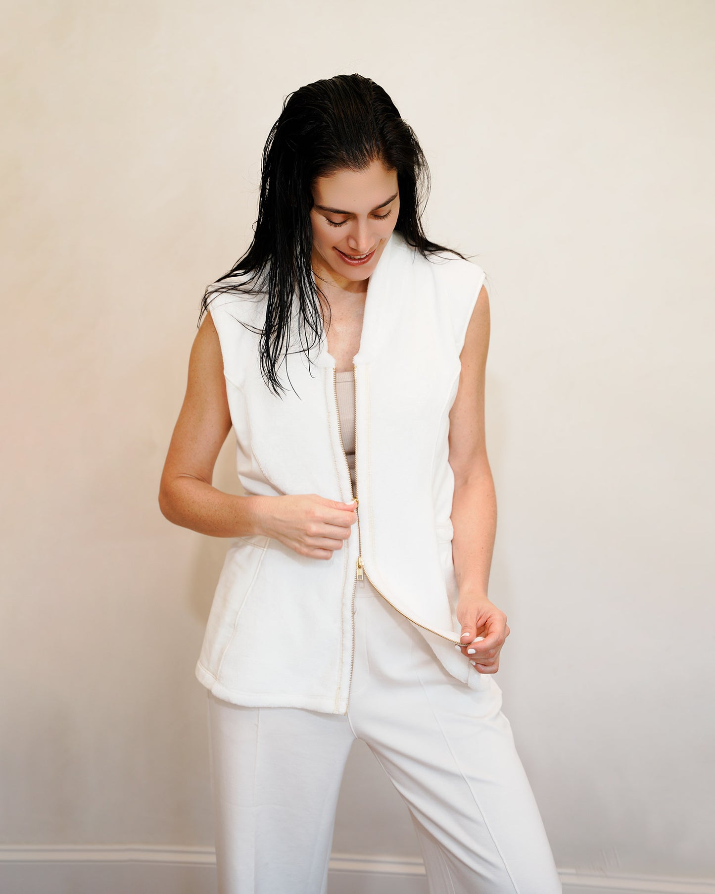 Woman wearing a post shower vest PSV against a plain background