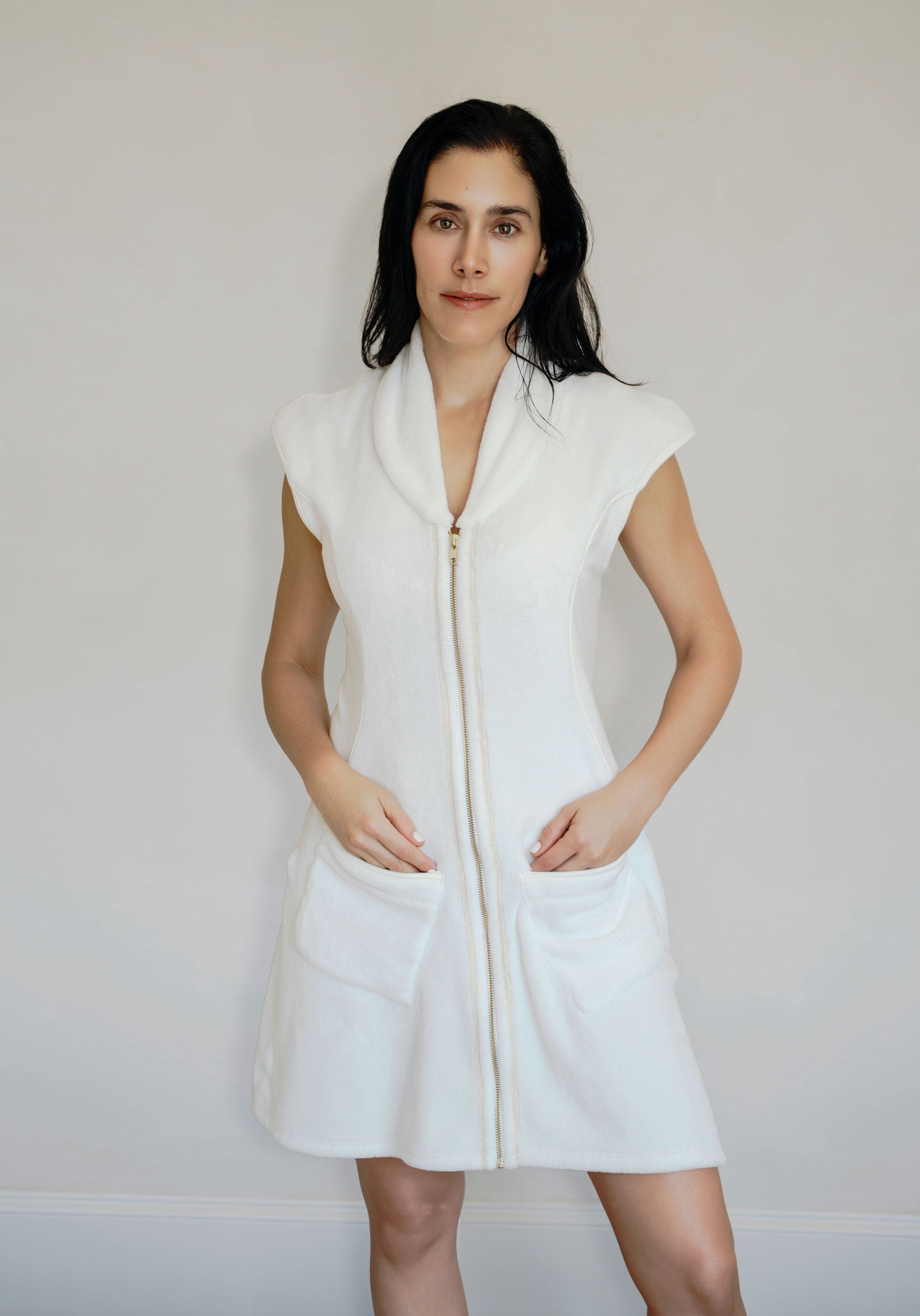 Woman wearing a post shower vest PSV on a plain background