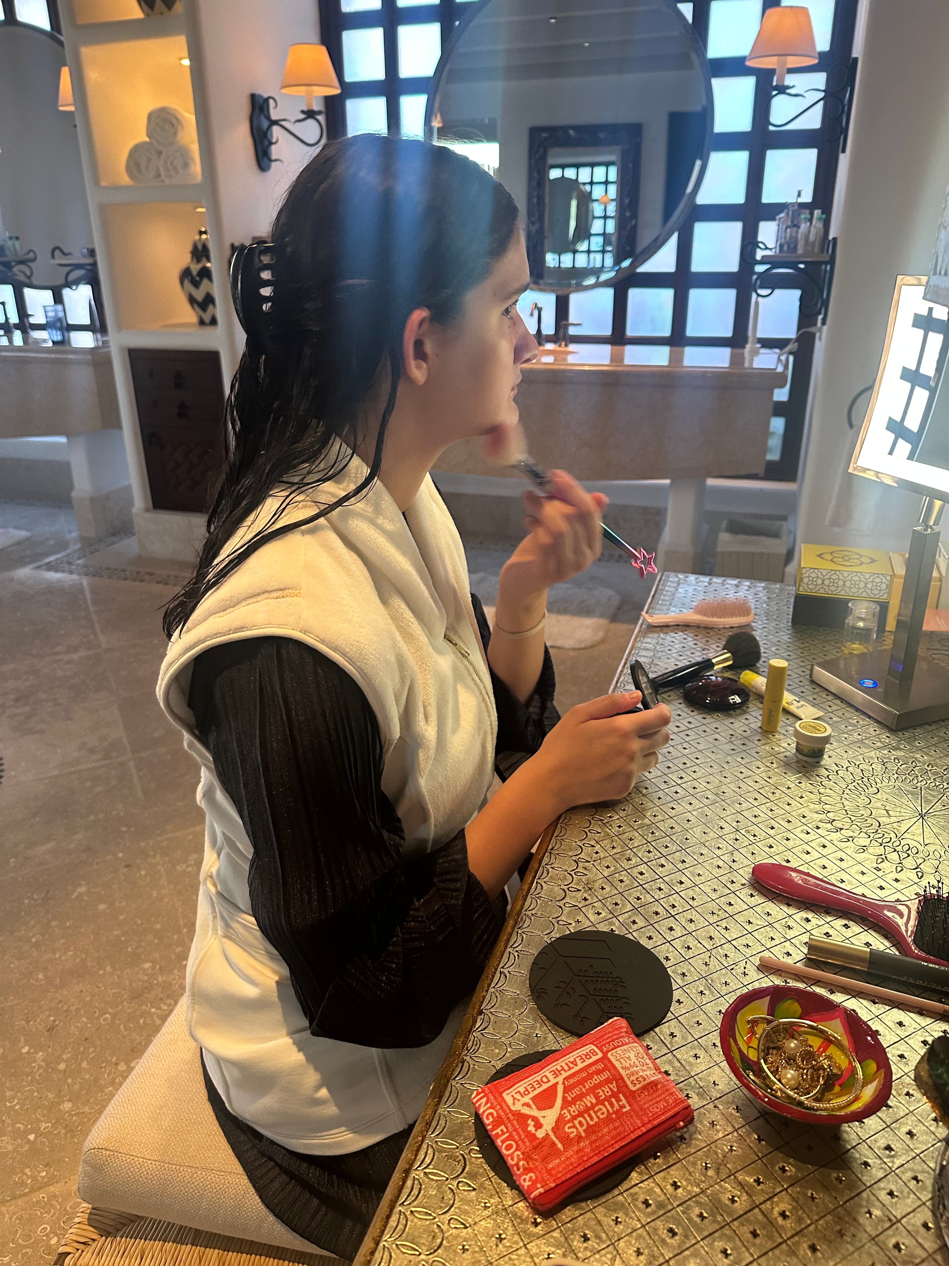 A girl with dark hair wearing the post shower vest