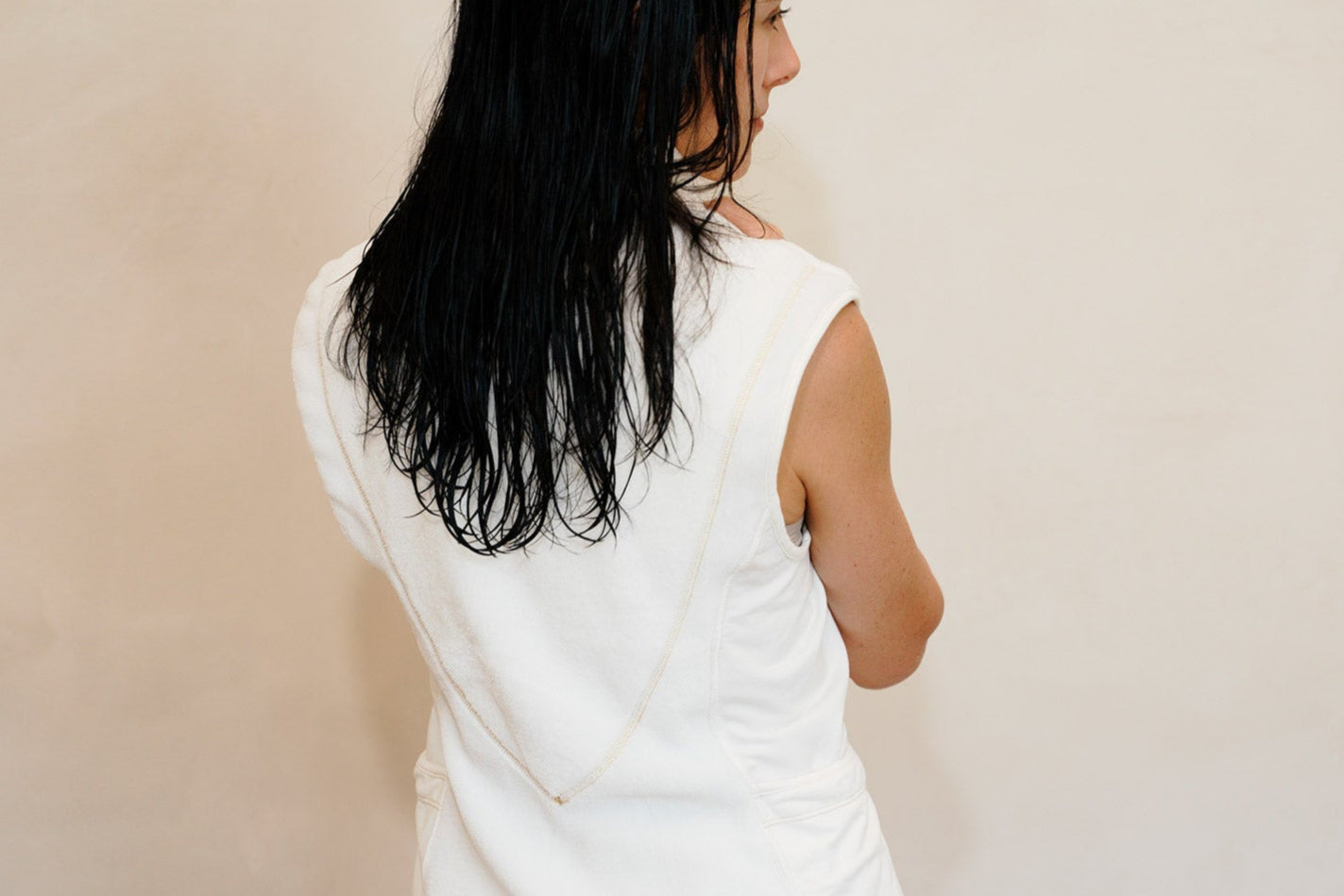 Woman with wet hair wearing RoMia24 PSV Post shower vest- air dry design
