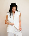 Woman wearing a post shower vest PSV almost open over clothes